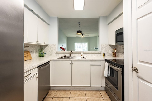 kitchen featuring white cabinetry, appliances with stainless steel finishes, light tile patterned flooring, and ceiling fan