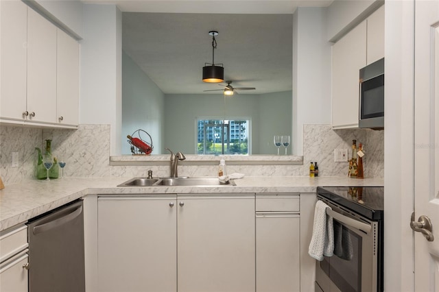 kitchen with white cabinetry, sink, and appliances with stainless steel finishes