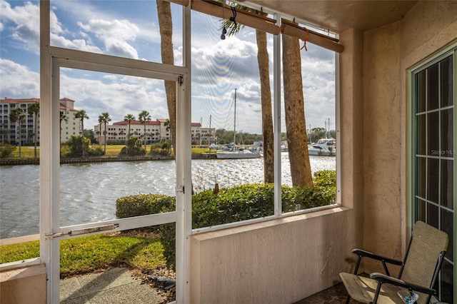 sunroom / solarium with a water view and plenty of natural light