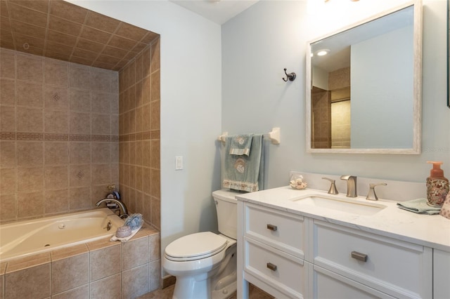 full bathroom featuring vanity, tiled shower / bath, and toilet