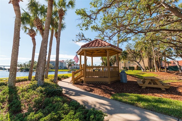 exterior space featuring a gazebo and a deck with water view