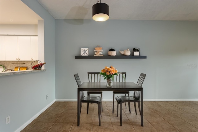 dining room with dark tile patterned flooring