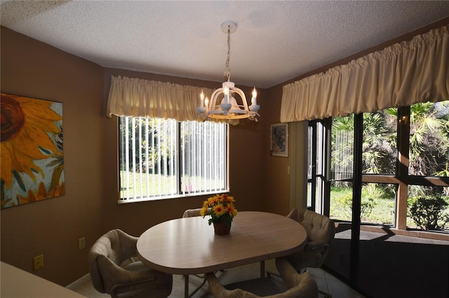 dining area with a notable chandelier and a textured ceiling