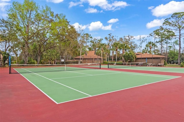 view of tennis court with basketball hoop