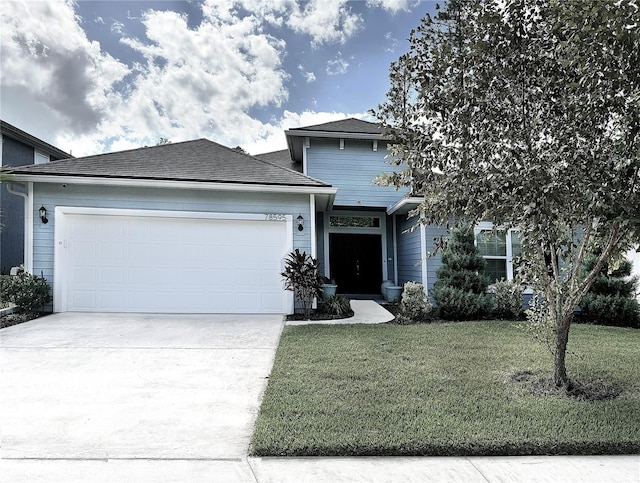 view of front facade with a garage and a front yard