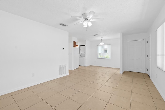 unfurnished room featuring light tile patterned floors, a textured ceiling, and ceiling fan