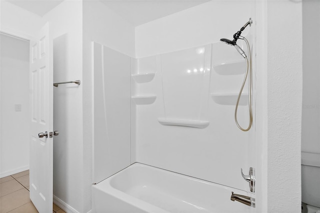 bathroom with tile patterned floors and washtub / shower combination