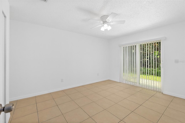 tiled spare room with ceiling fan