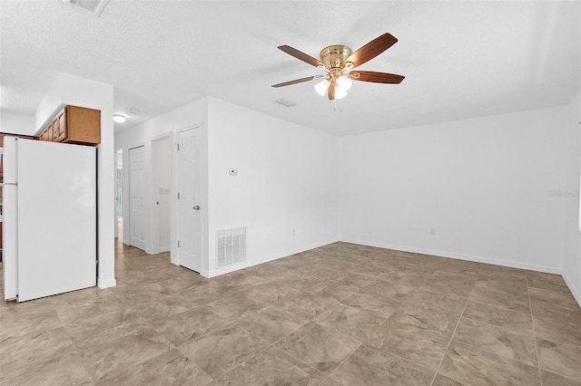 interior space with a textured ceiling and ceiling fan