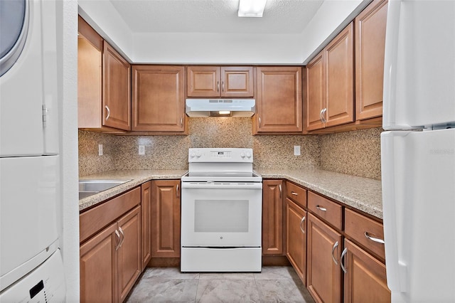 kitchen featuring sink, white appliances, and backsplash