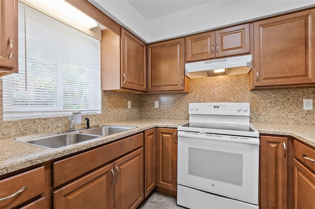 kitchen with decorative backsplash, light tile patterned floors, white range with electric cooktop, and sink