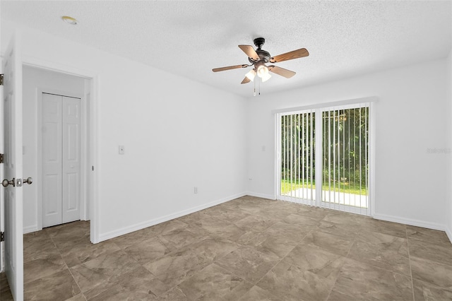 spare room with ceiling fan and a textured ceiling