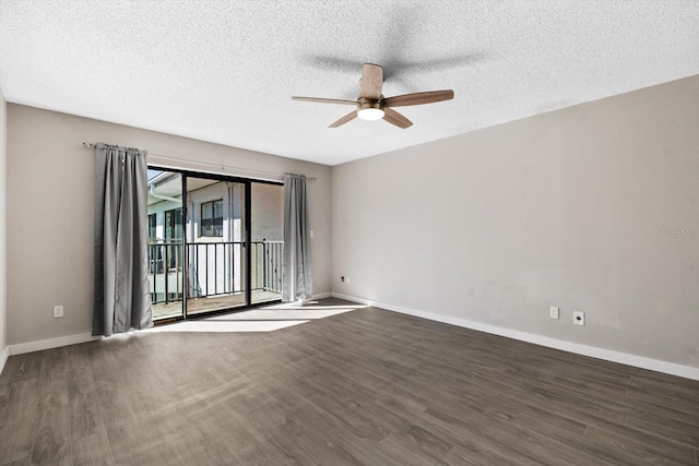 unfurnished room with ceiling fan, dark wood-type flooring, and a textured ceiling