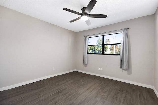 spare room featuring a textured ceiling, ceiling fan, and dark wood-type flooring