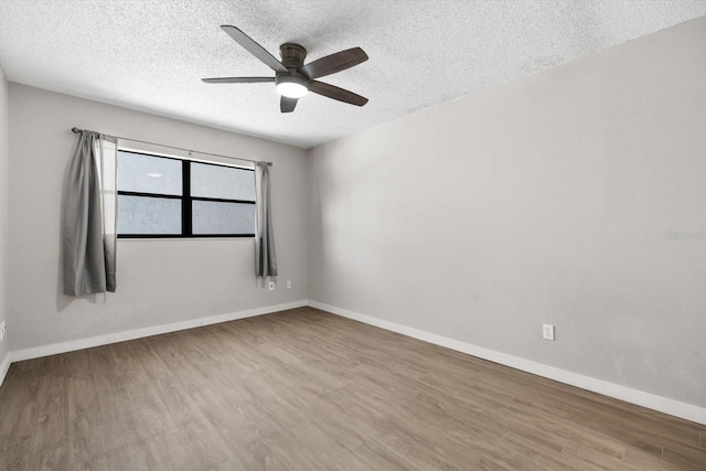 empty room featuring wood-type flooring, a textured ceiling, and ceiling fan