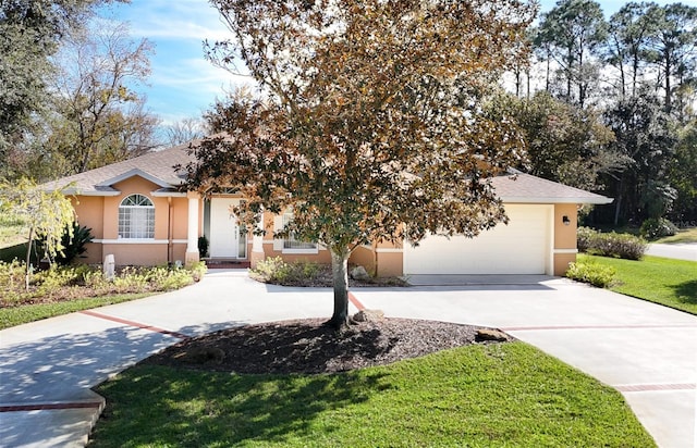 view of front of property with a garage and a front lawn