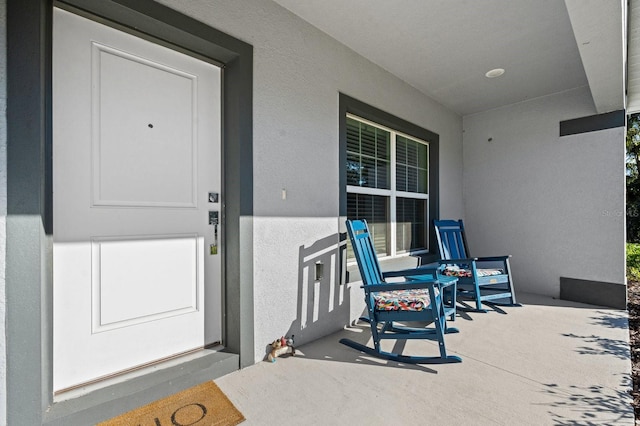 view of exterior entry featuring a porch