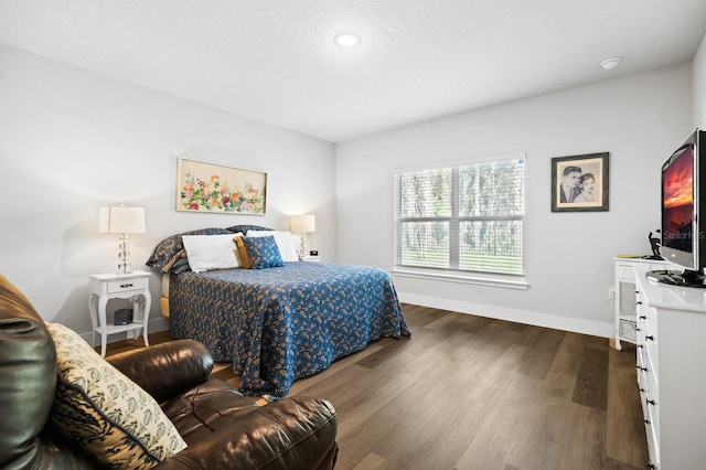 bedroom with dark hardwood / wood-style flooring