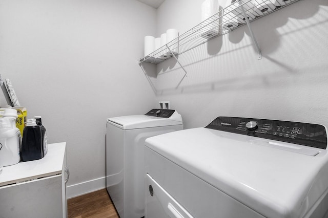 laundry room featuring dark hardwood / wood-style flooring and washing machine and dryer