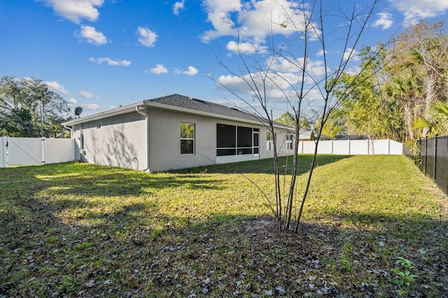 rear view of property with a lawn