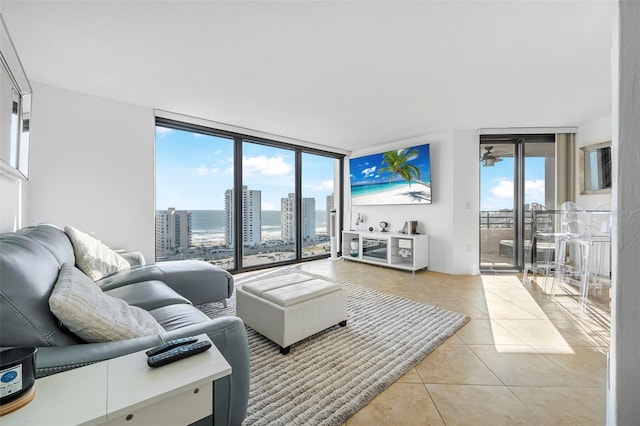 living room with floor to ceiling windows and light tile patterned flooring