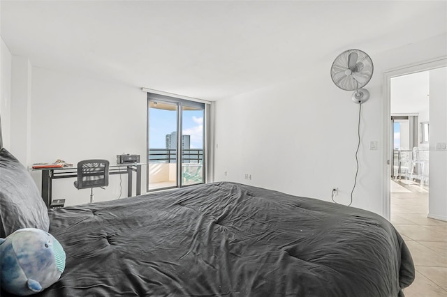 tiled bedroom with access to exterior and a wall of windows