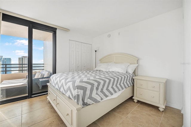 tiled bedroom featuring access to outside and a closet