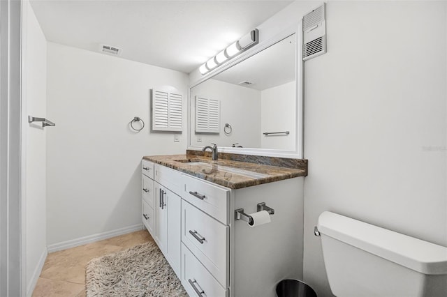 bathroom with tile patterned floors, vanity, and toilet