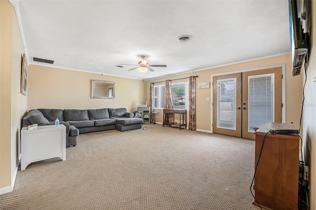 carpeted living room featuring ceiling fan, ornamental molding, and french doors