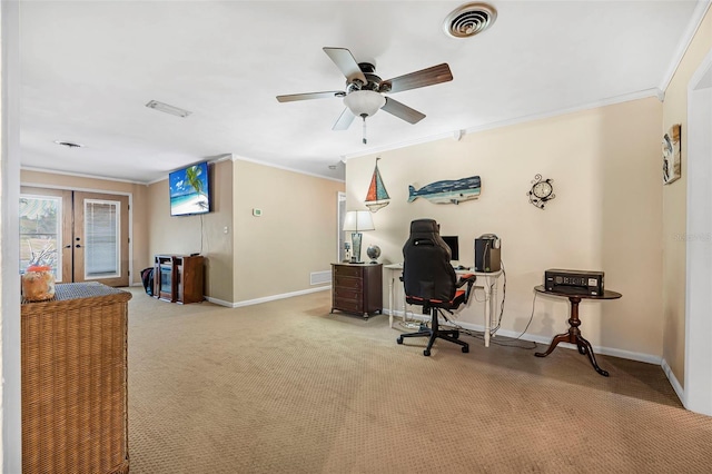 carpeted home office with ceiling fan, ornamental molding, and french doors