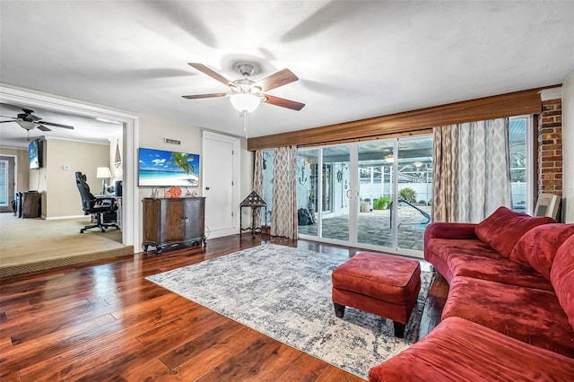 living room with ceiling fan and dark hardwood / wood-style flooring