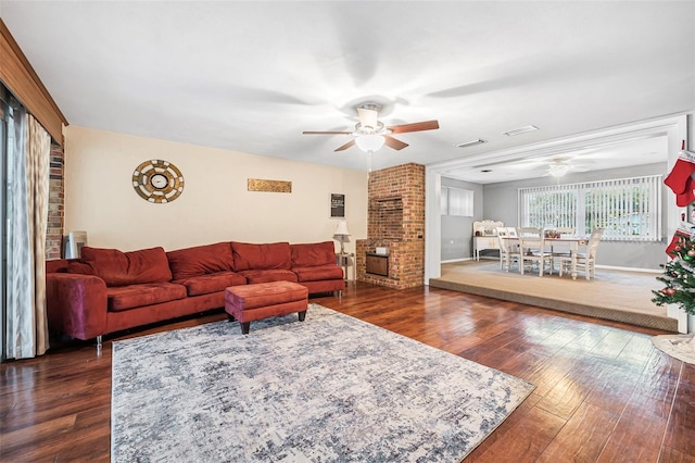 living room with ceiling fan and dark hardwood / wood-style flooring