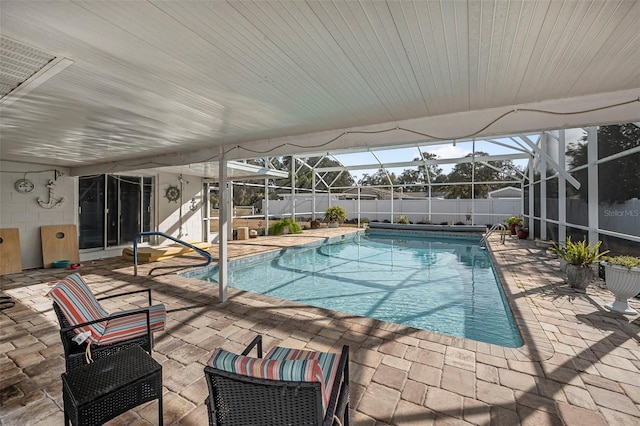 view of pool with a patio area and a lanai