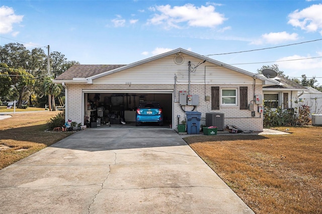 view of front of home with central air condition unit, a garage, and a front lawn