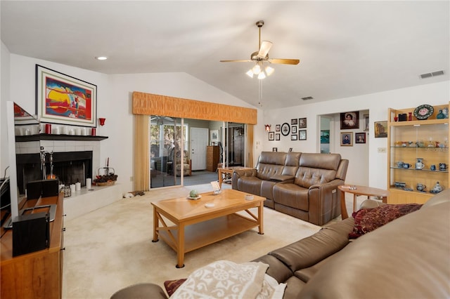 carpeted living room with ceiling fan, a fireplace, and lofted ceiling