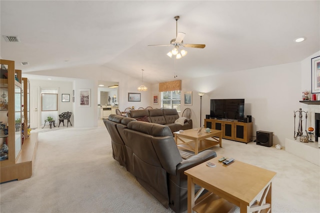 living room with light carpet, vaulted ceiling, and ceiling fan