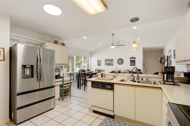 kitchen featuring white dishwasher, sink, vaulted ceiling, stainless steel fridge, and decorative light fixtures