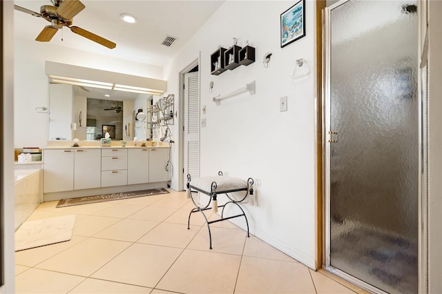 bathroom with tile patterned flooring, vanity, walk in shower, and ceiling fan