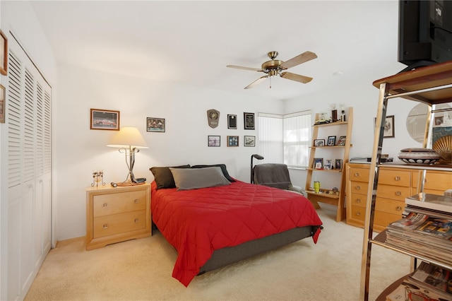 carpeted bedroom with ceiling fan and a closet