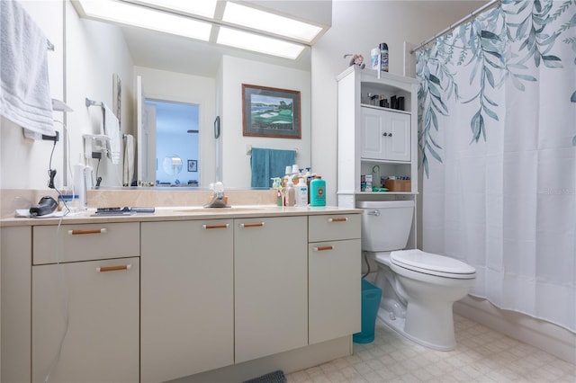 bathroom featuring vanity, toilet, and walk in shower