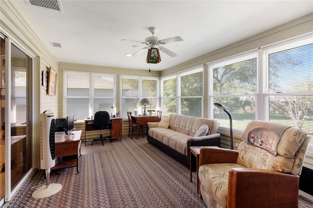 sunroom featuring ceiling fan