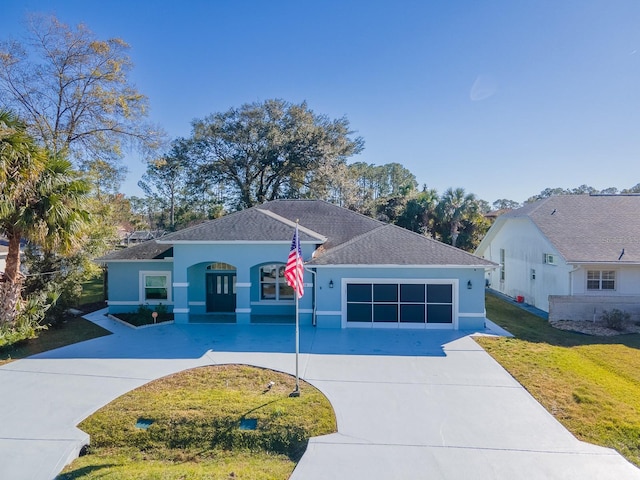 view of front of property with a front yard and a garage