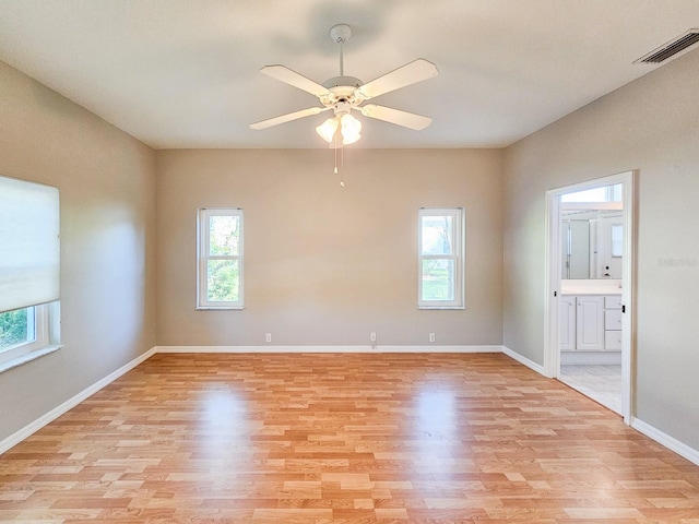 spare room with light hardwood / wood-style floors and ceiling fan