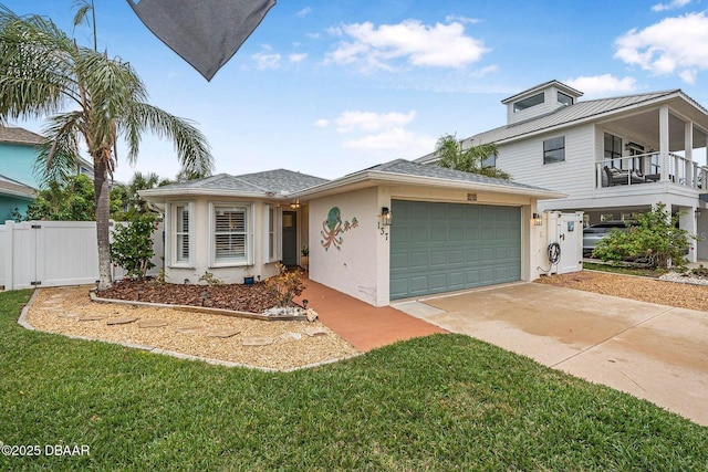 view of front of property with a garage, a balcony, and a front lawn