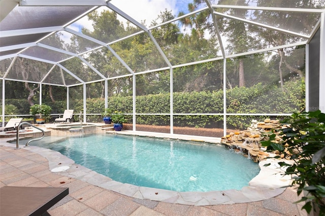 view of swimming pool featuring an in ground hot tub, a lanai, and a patio area