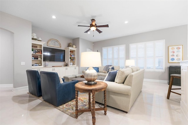 tiled living room featuring ceiling fan