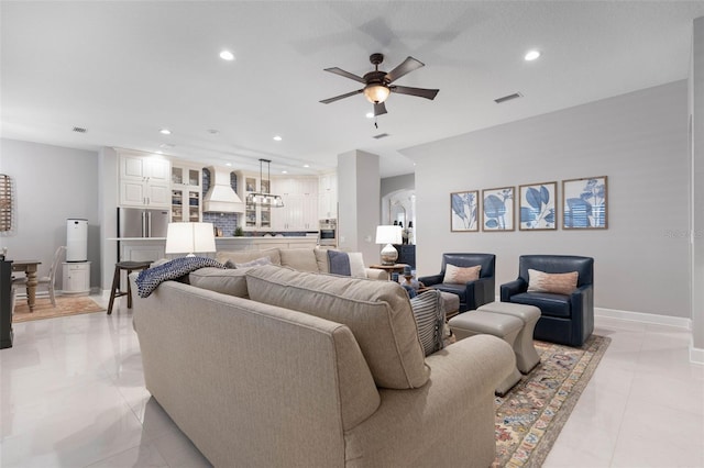 tiled living room with ceiling fan