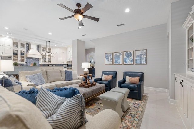 tiled living room featuring ceiling fan