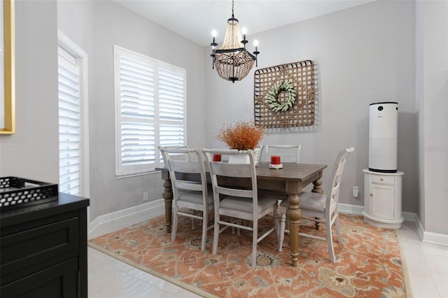 dining space with light tile patterned flooring and a notable chandelier