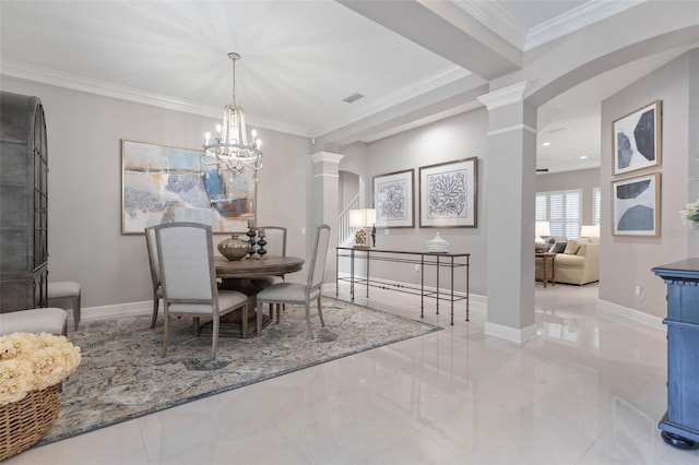 dining room featuring ornate columns, ornamental molding, and a notable chandelier